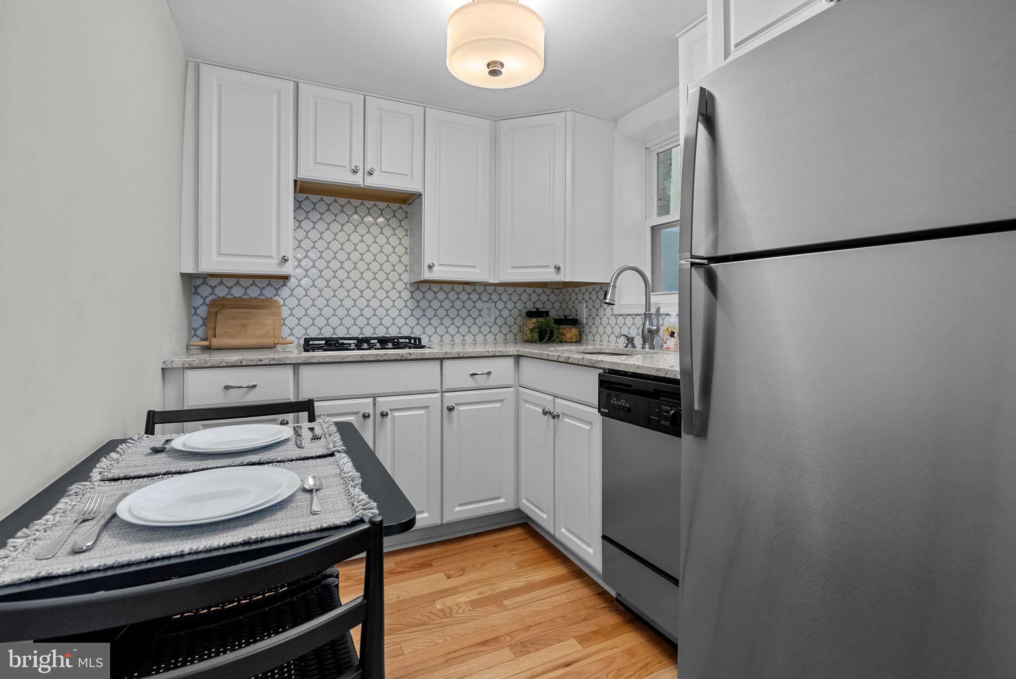 1917 Rodman Street Philadelphia, PA 19146 - Photo 8 of 31 a kitchen with stainless steel appliances a stove a sink and a refrigerator