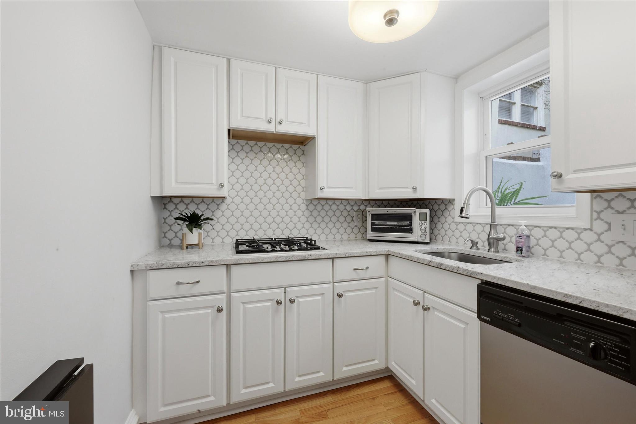 1917 Rodman Street Philadelphia, PA 19146 - Photo 9 of 31 a kitchen with white cabinets and white appliances