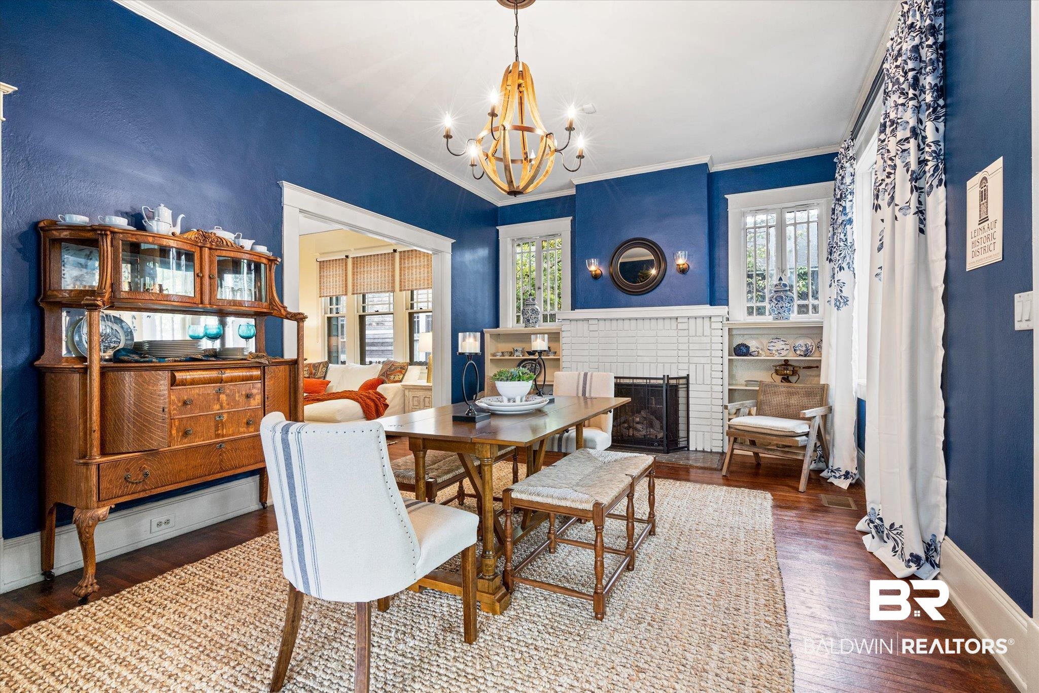 466 Michigan Avenue Mobile, AL 36604 - Photo 15 of 38 Dining room featuring dark hardwood floors, a notable chandelier, crown molding, and a working gas log fireplace. This was the original living room.