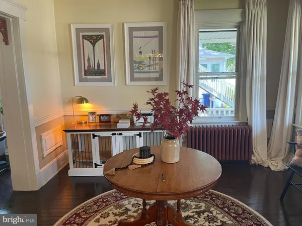 a dining room with furniture a rug and wooden floor