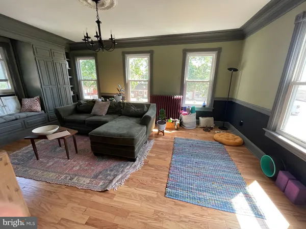 a living room with furniture and a chandelier