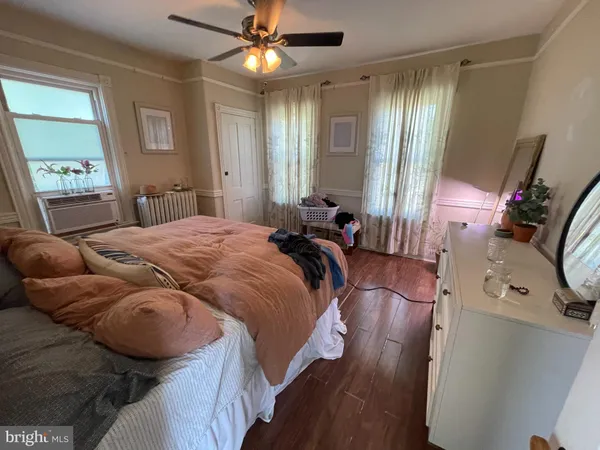 a bed room with a bed window and a mirror