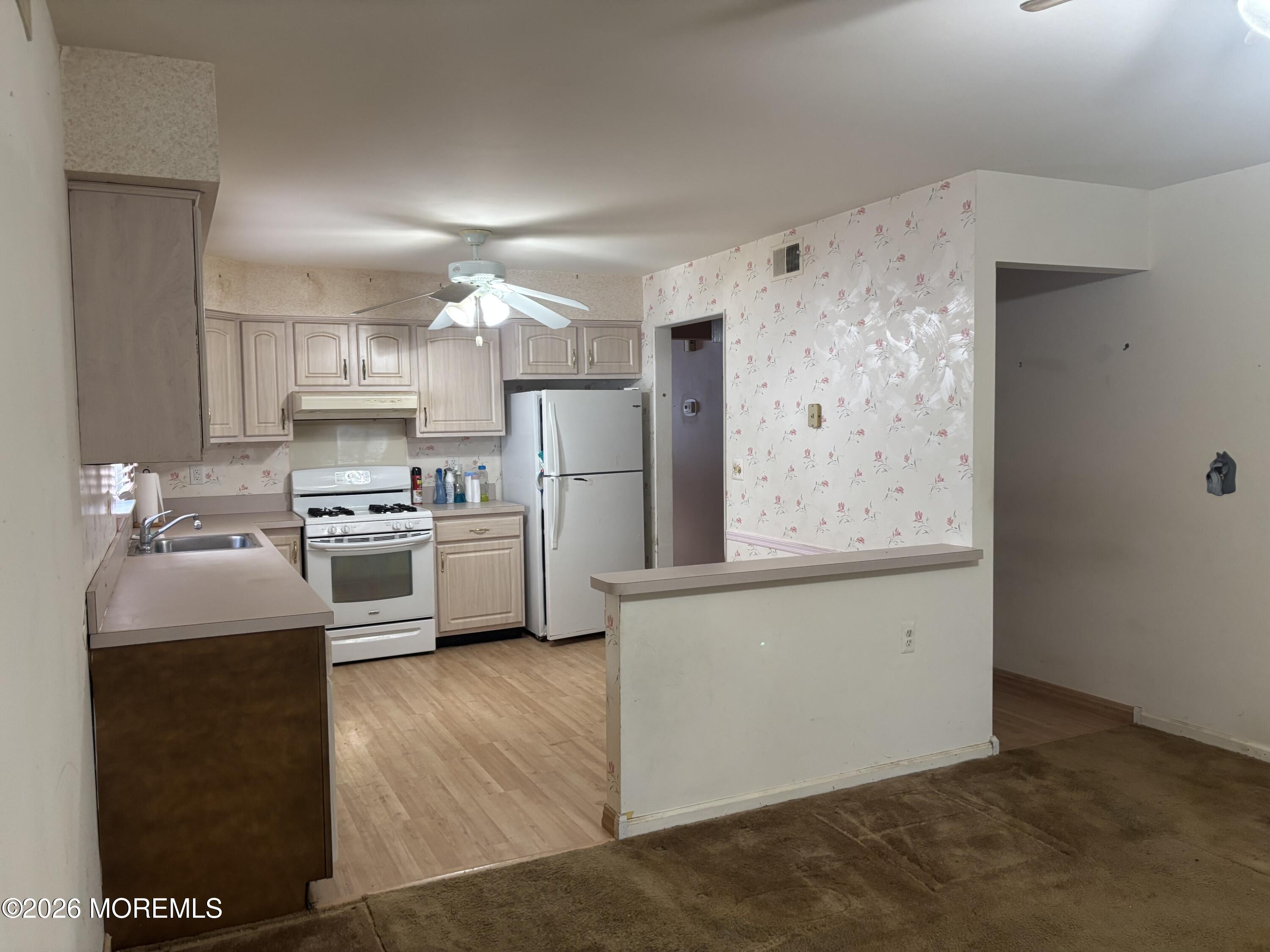 24 Olympus Way Brick, NJ 08724 - Photo 4 of 22 a kitchen with stainless steel appliances a refrigerator sink and stove