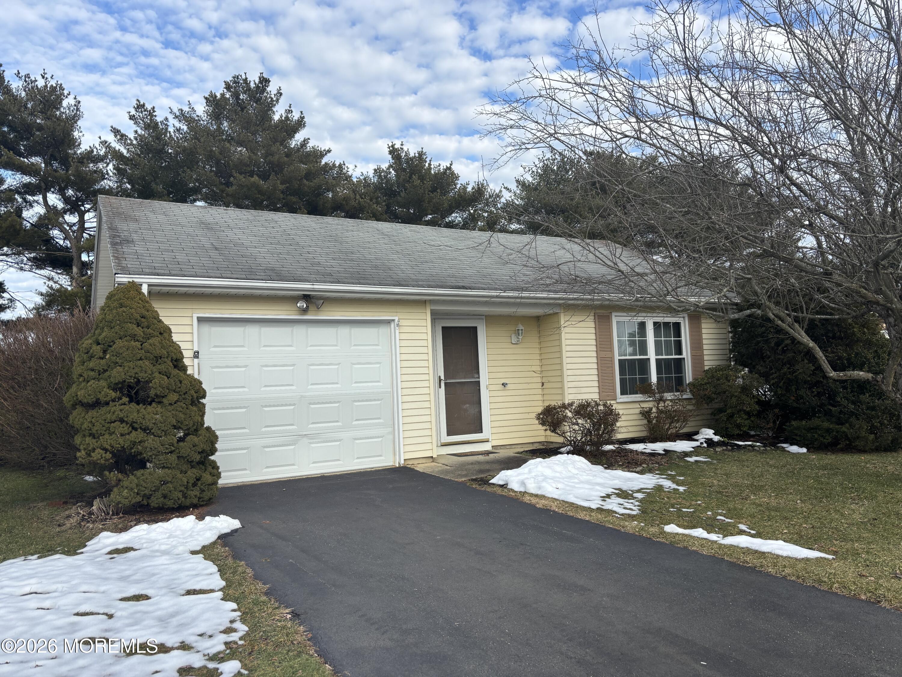 24 Olympus Way Brick, NJ 08724 - Photo 5 of 22 a front view of a house with a yard and garage