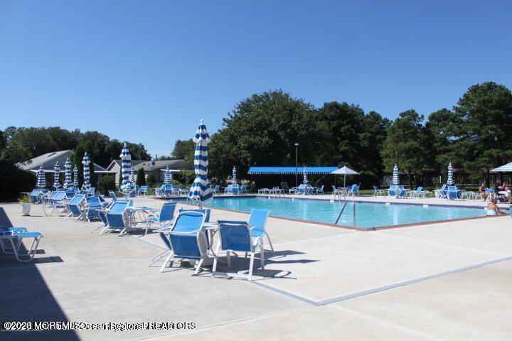 24 Olympus Way Brick, NJ 08724 - Photo 8 of 22 a view of a swimming pool with outdoor seating