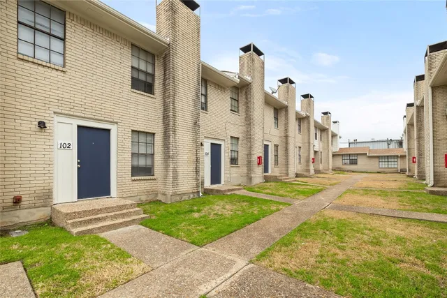 a view of a white apartments with large windows