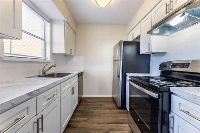 a kitchen with a stove and a sink