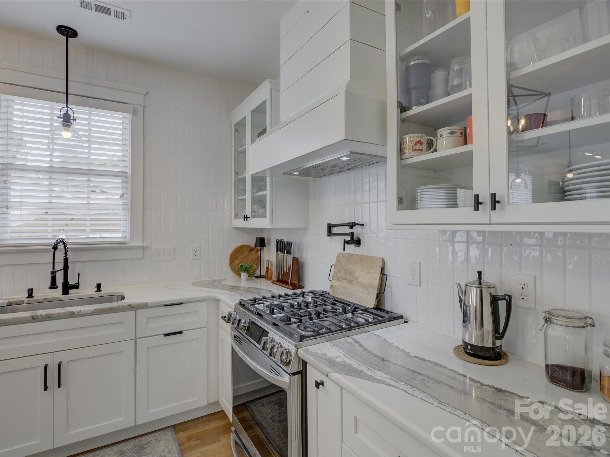 1305 Barnett Woods Crossing Fort Mill, SC 29708 - Photo 11 of 48 a kitchen with sink a stove and cabinets