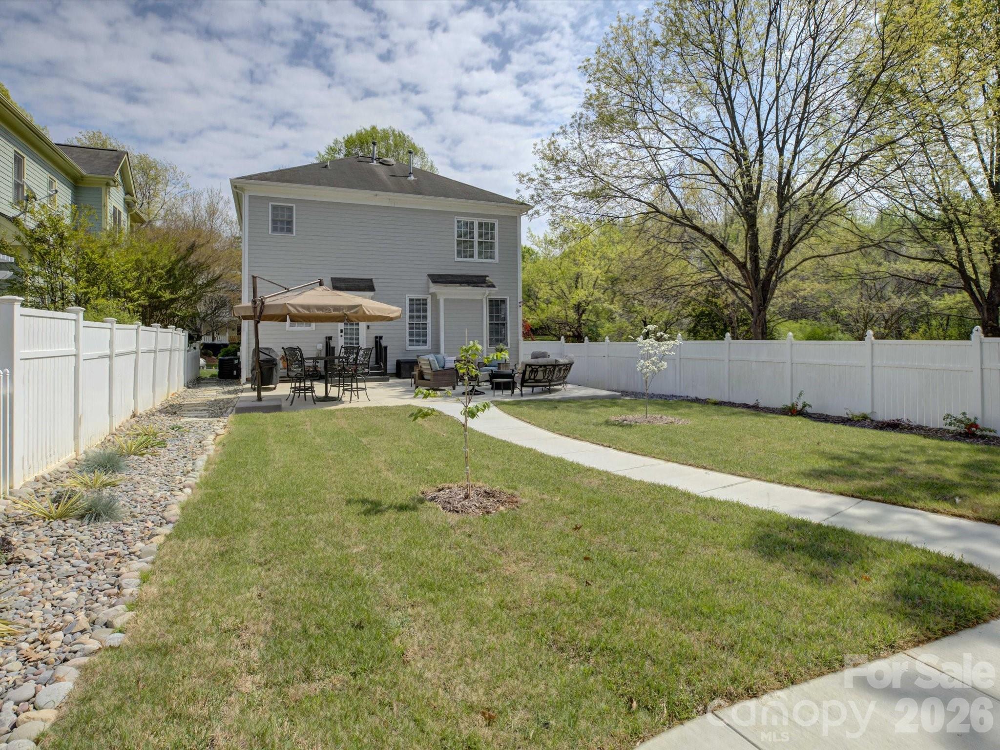 1305 Barnett Woods Crossing Fort Mill, SC 29708 - Photo 15 of 48 a view of a house with a yard patio and fire pit