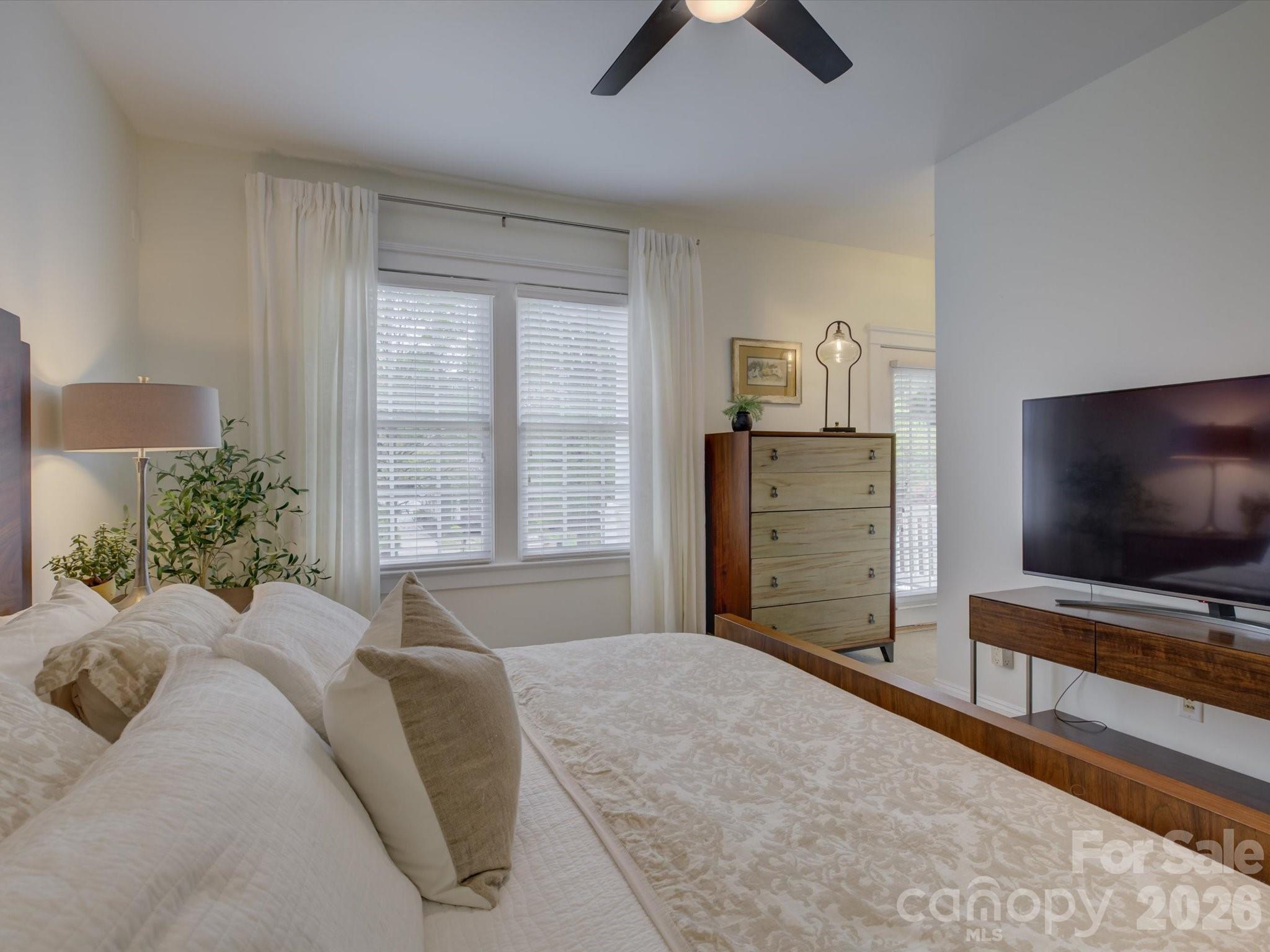 1305 Barnett Woods Crossing Fort Mill, SC 29708 - Photo 20 of 48 a bedroom with a bed and a flat screen tv