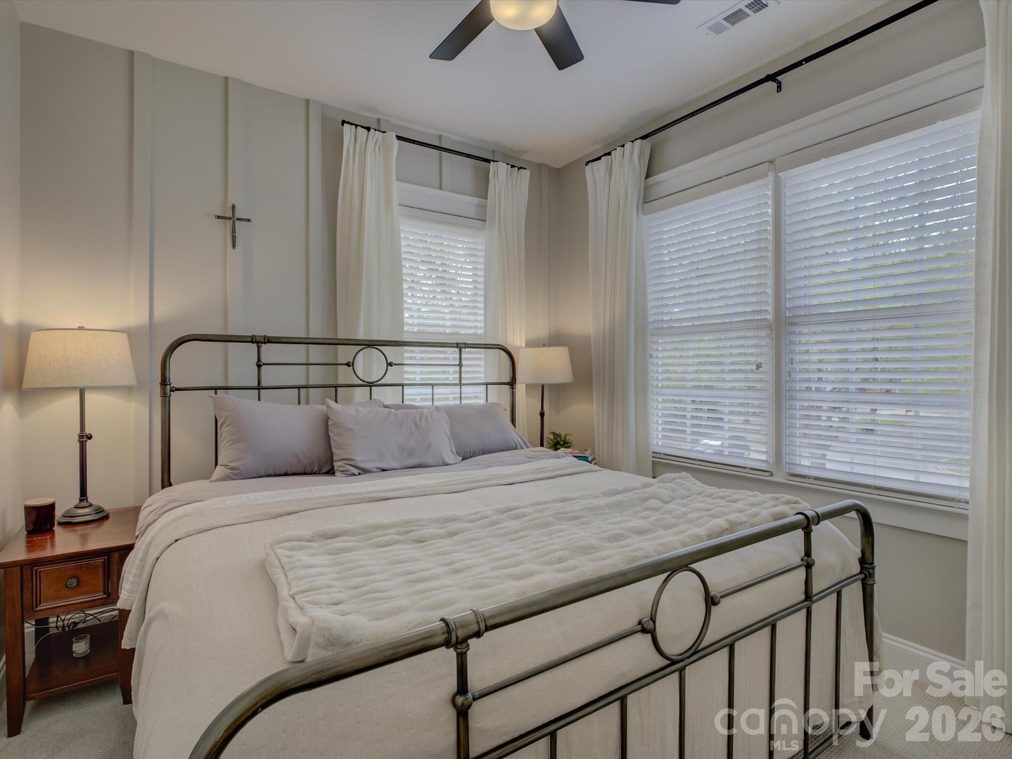 1305 Barnett Woods Crossing Fort Mill, SC 29708 - Photo 28 of 48 a bedroom with a bed and a chandelier