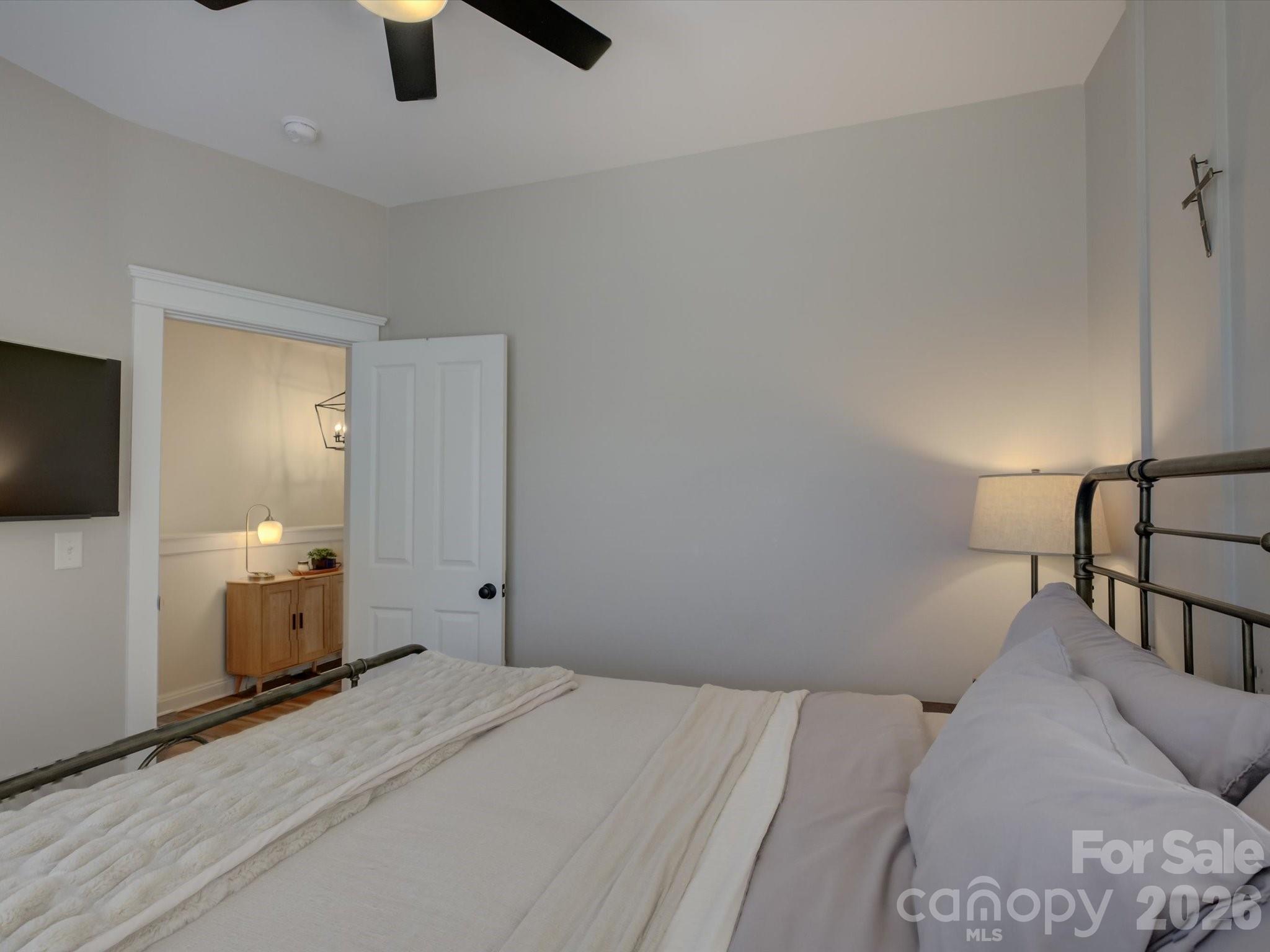 1305 Barnett Woods Crossing Fort Mill, SC 29708 - Photo 29 of 48 a bedroom with a large bed and a chandelier