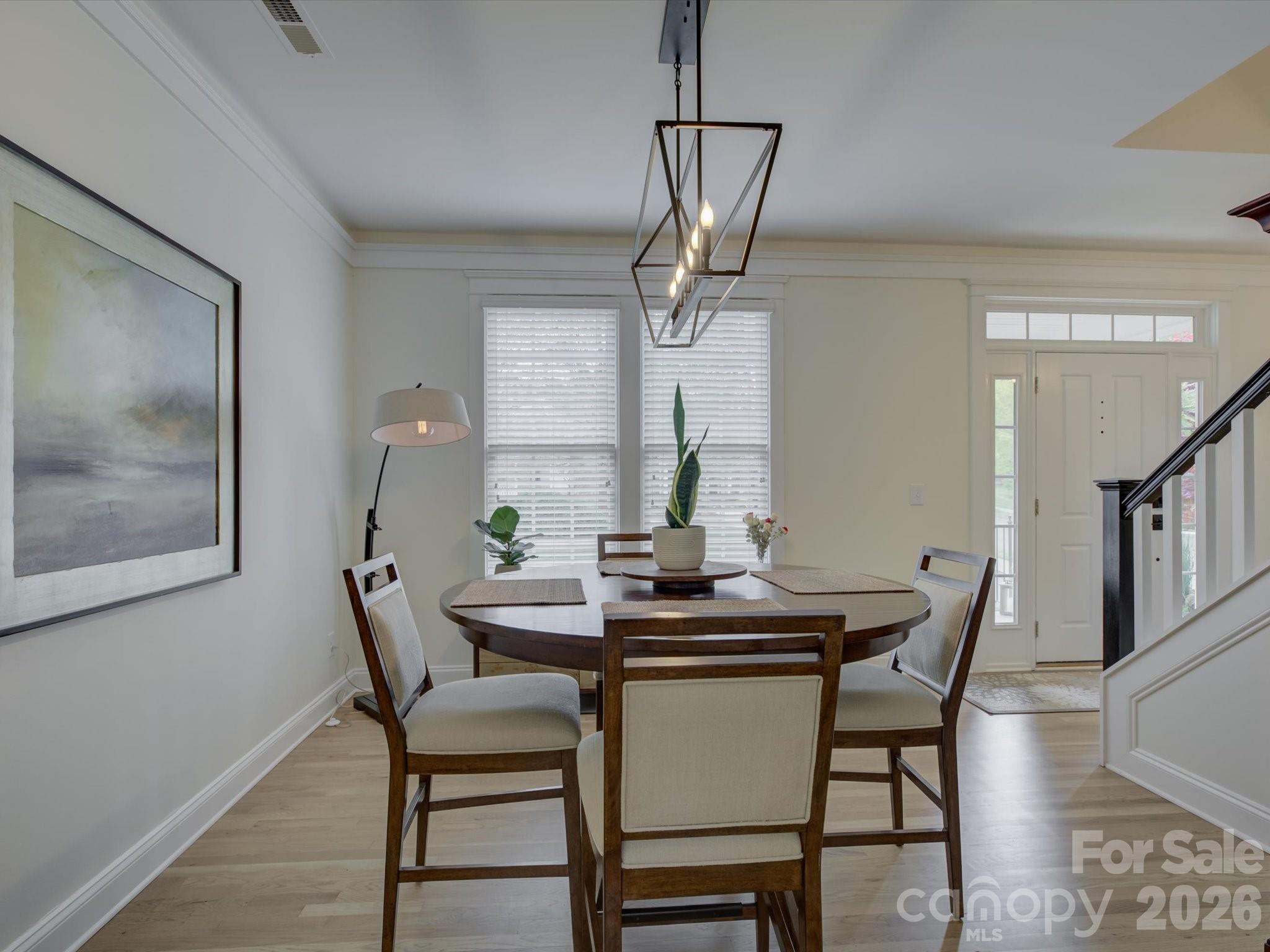 1305 Barnett Woods Crossing Fort Mill, SC 29708 - Photo 6 of 48 a view of a dining room with furniture and wooden floor