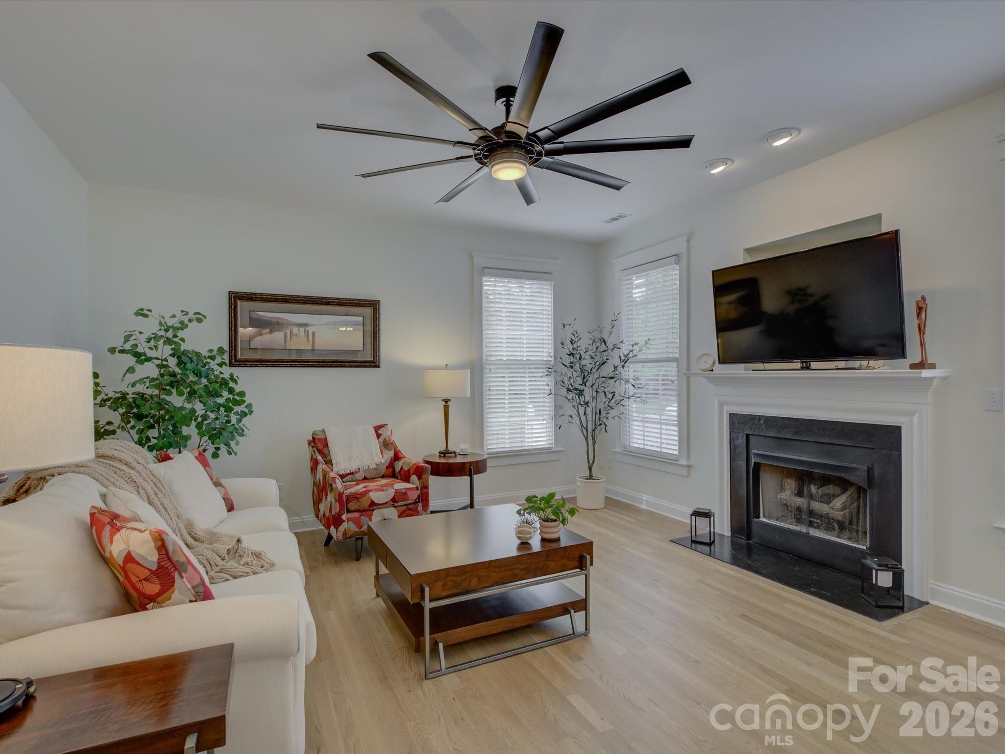 1305 Barnett Woods Crossing Fort Mill, SC 29708 - Photo 7 of 48 a living room with furniture a fireplace and a flat screen tv
