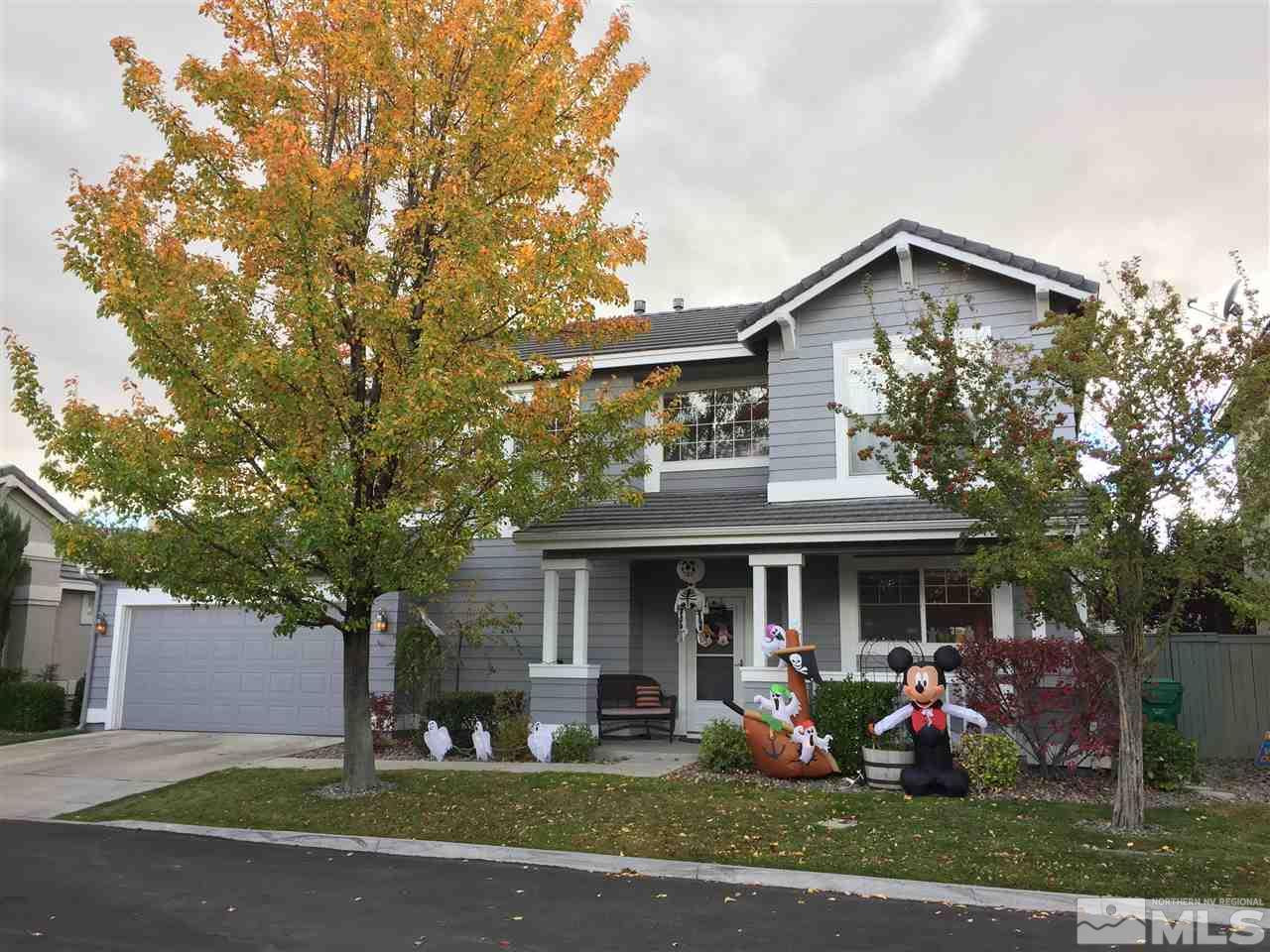 9687 Otter Way Reno, NV 89521 - Photo 1 of 1 a front view of a house with garden and trees