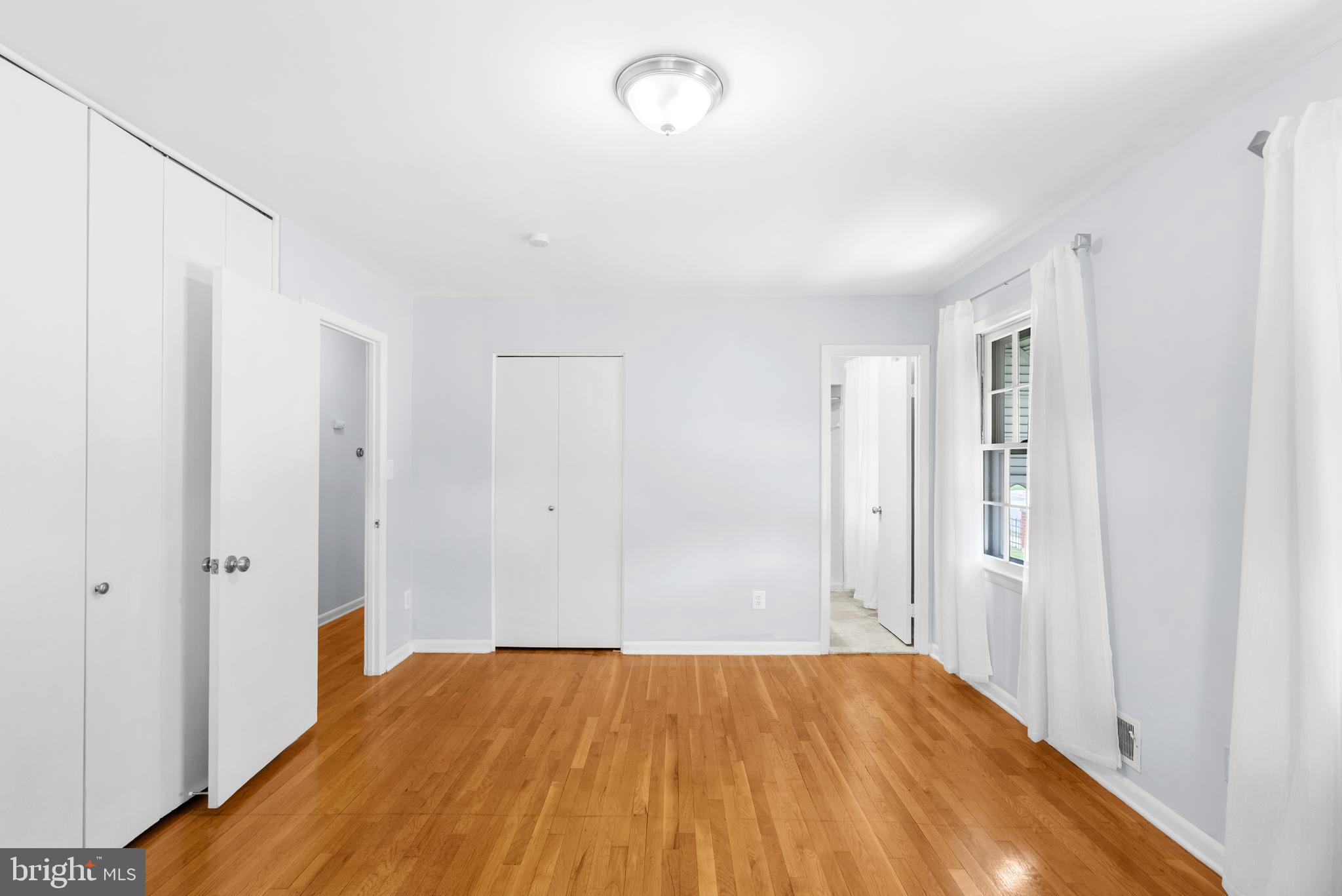 1201 Chillum Manor Road Hyattsville, MD 20783 - Photo 27 of 49 a view of a room with wooden floor and a bathroom
