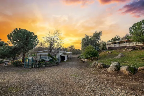 a view of a house with a yard and sitting area