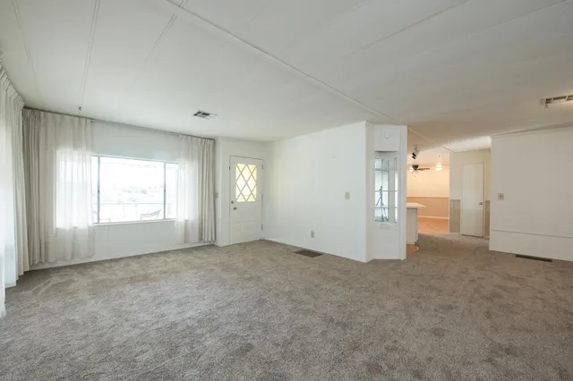a view of a kitchen with a sink and a ceiling fan