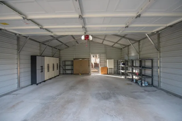 a backyard of a house with barbeque oven table and chairs