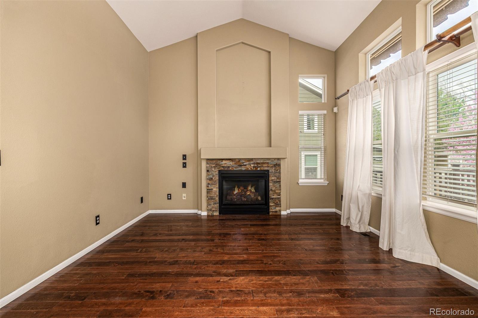 10244 Royal Eagle Street Highlands Ranch, CO 80129 - Photo 11 of 46 a view of a livingroom with a fireplace and window