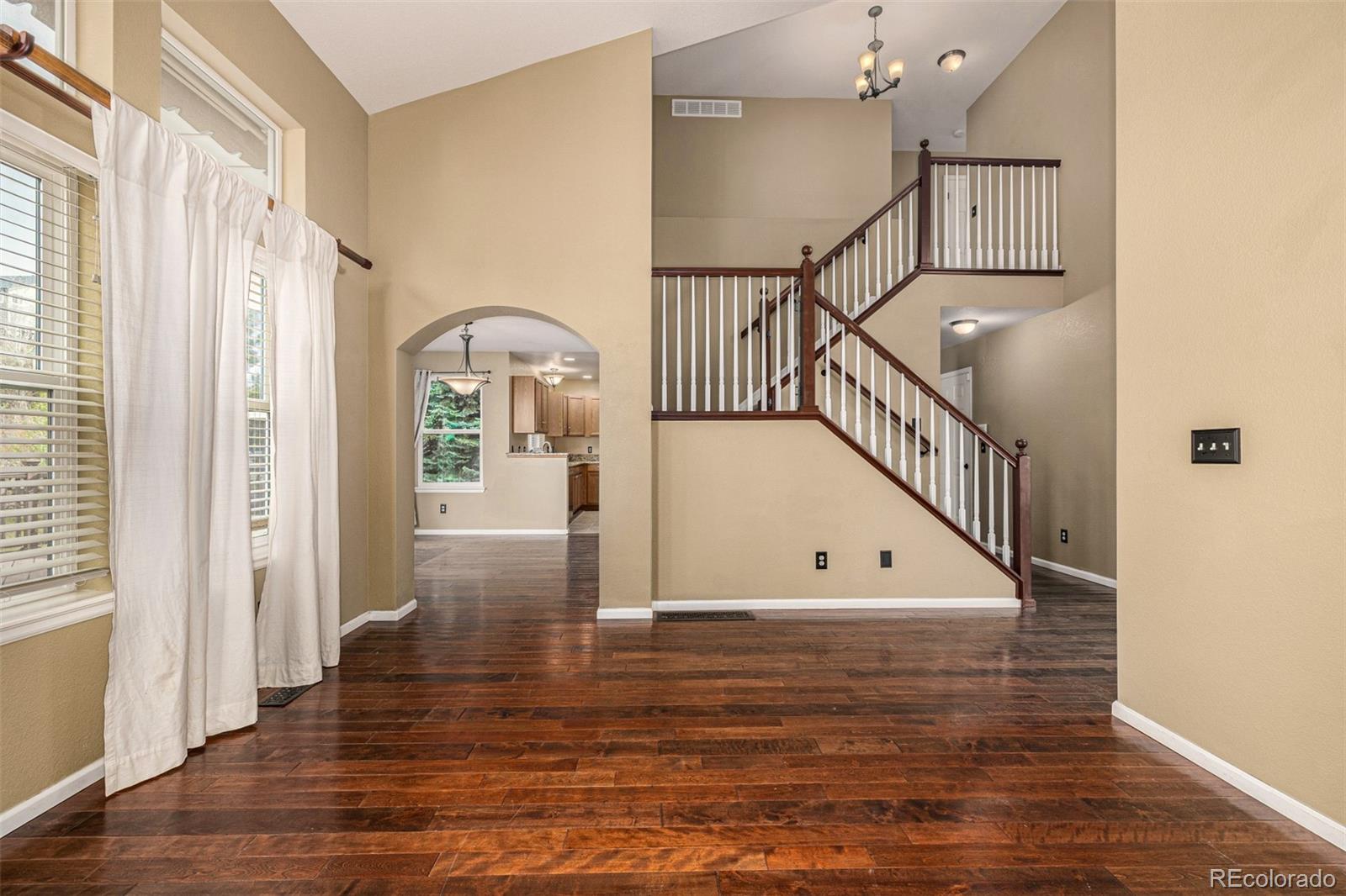 10244 Royal Eagle Street Highlands Ranch, CO 80129 - Photo 13 of 46 a view of entryway and hall with wooden floor