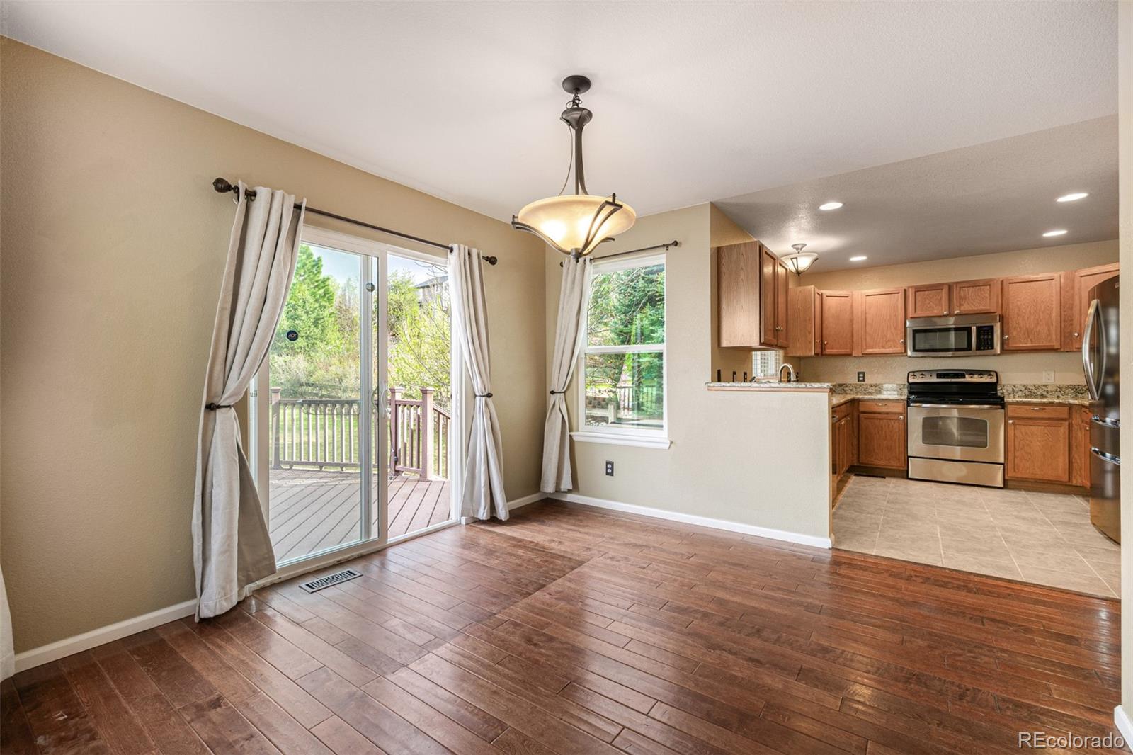 10244 Royal Eagle Street Highlands Ranch, CO 80129 - Photo 14 of 46 a view of a kitchen with furniture wooden floor and a window