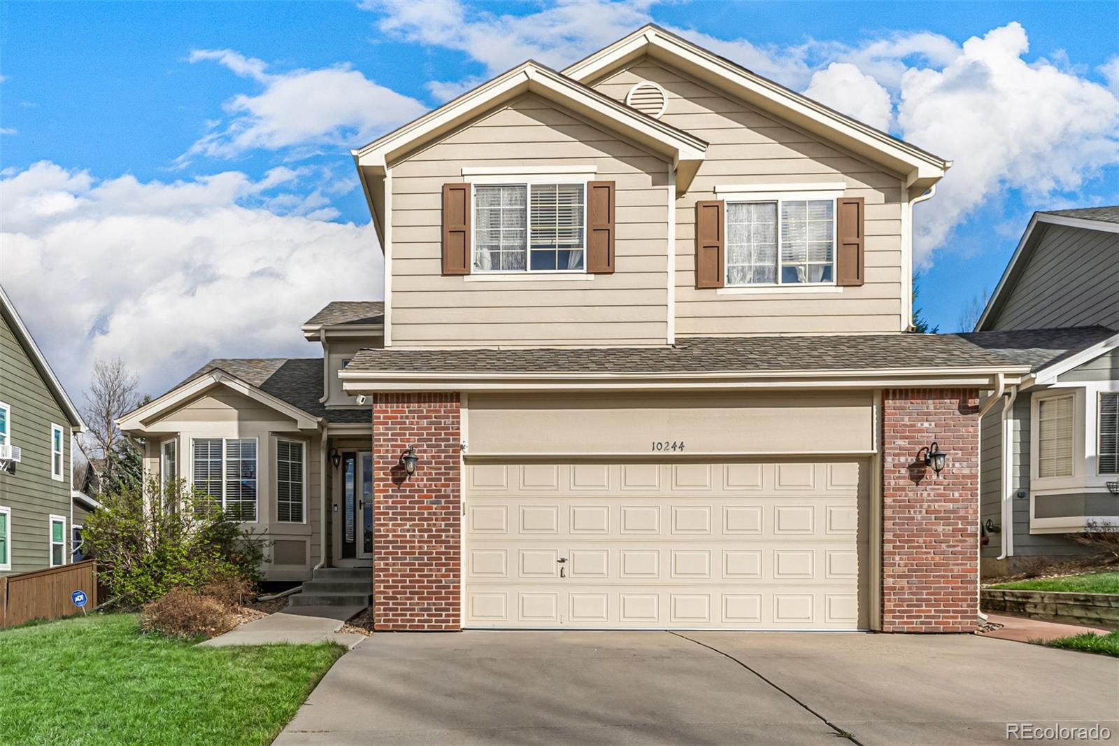10244 Royal Eagle Street Highlands Ranch, CO 80129 - Photo 2 of 46 a front view of a house with a yard