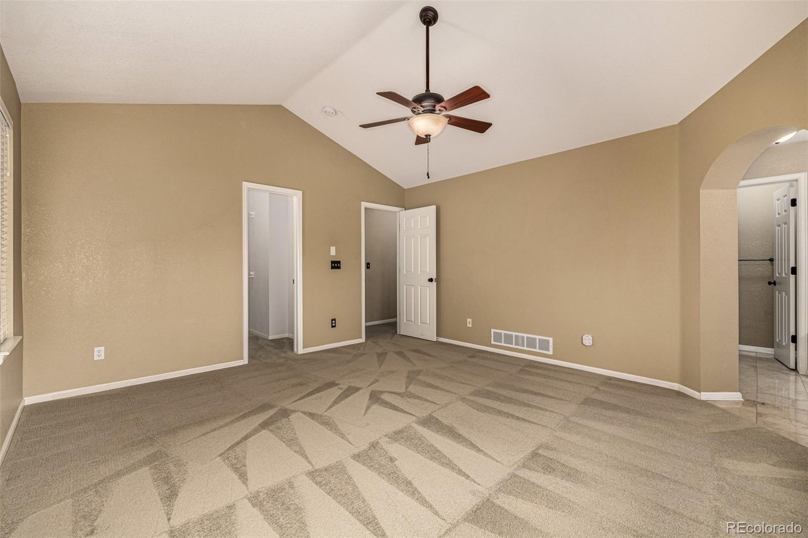 10244 Royal Eagle Street Highlands Ranch, CO 80129 - Photo 22 of 46 a view of an empty room with a chandelier fan