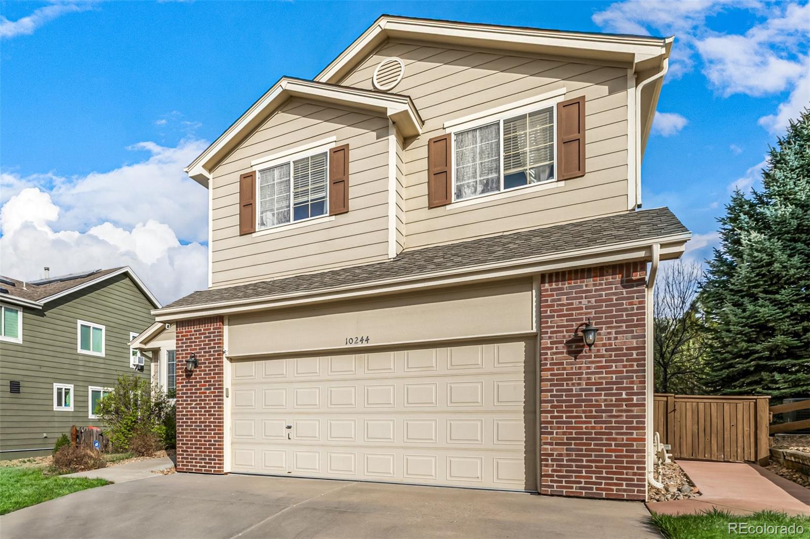 10244 Royal Eagle Street Highlands Ranch, CO 80129 - Photo 3 of 46 a front view of a house with a garage