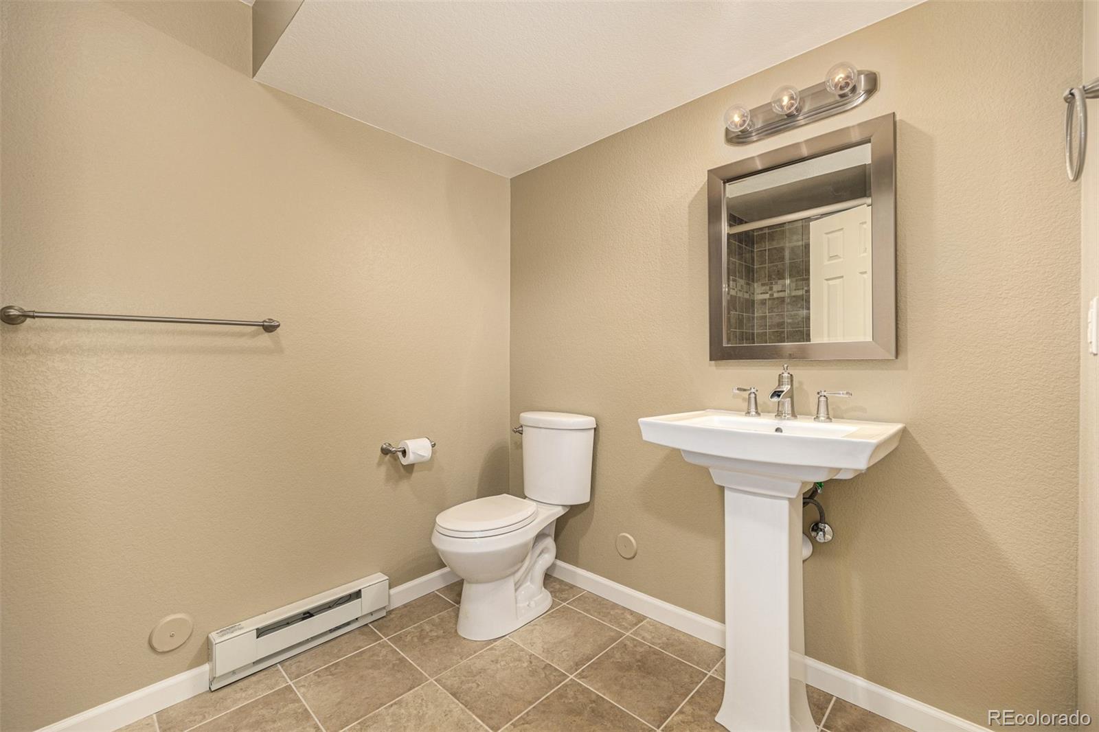 10244 Royal Eagle Street Highlands Ranch, CO 80129 - Photo 34 of 46 a bathroom with a sink toilet and a mirror