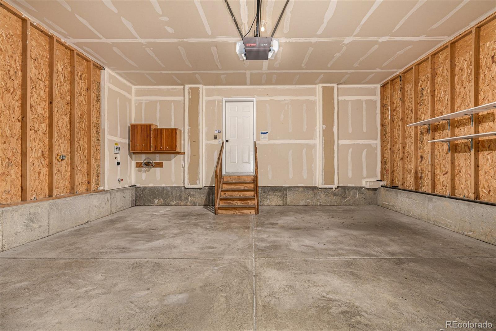 10244 Royal Eagle Street Highlands Ranch, CO 80129 - Photo 37 of 46 a view of a livingroom with furniture a flat screen tv and staircase