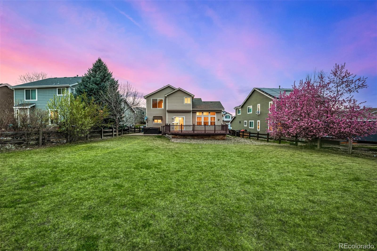 10244 Royal Eagle Street Highlands Ranch, CO 80129 - Photo 43 of 46 a front view of a house with a garden and trees