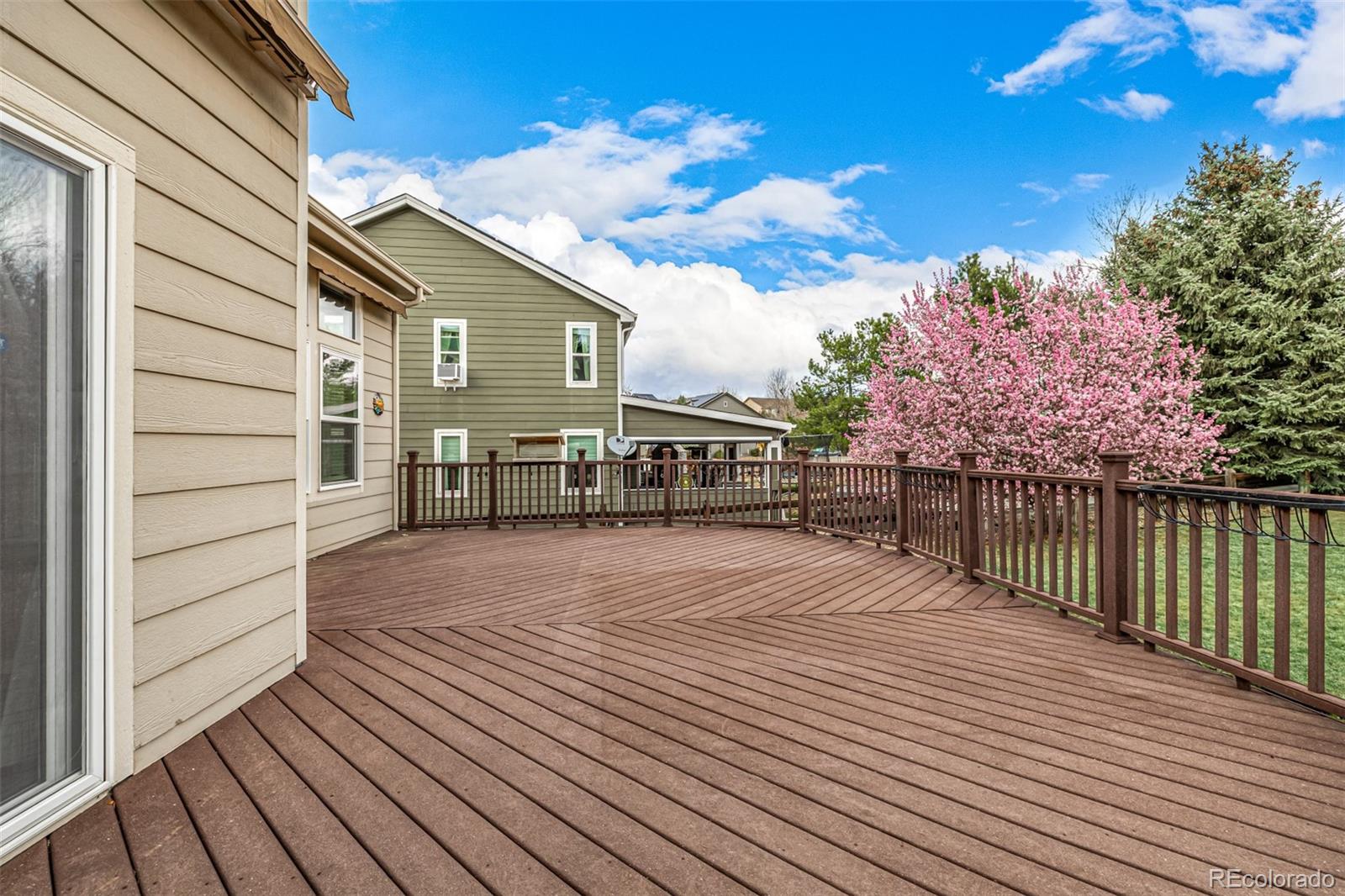 10244 Royal Eagle Street Highlands Ranch, CO 80129 - Photo 44 of 46 a balcony with wooden floor table and chair