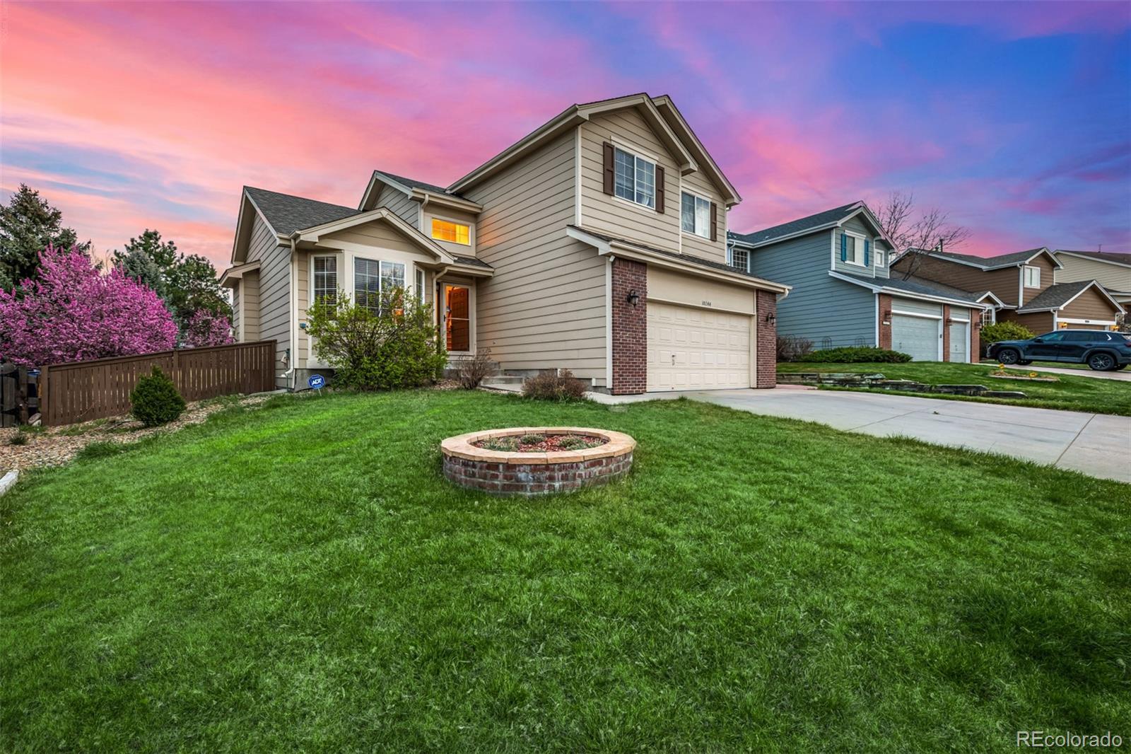 10244 Royal Eagle Street Highlands Ranch, CO 80129 - Photo 5 of 46 a front view of a house with a garden and plants