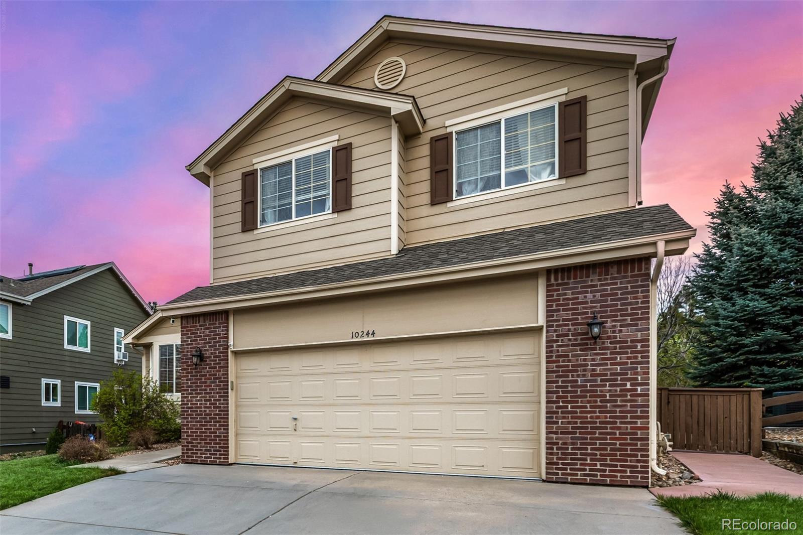 10244 Royal Eagle Street Highlands Ranch, CO 80129 - Photo 6 of 46 a front view of a house with garage