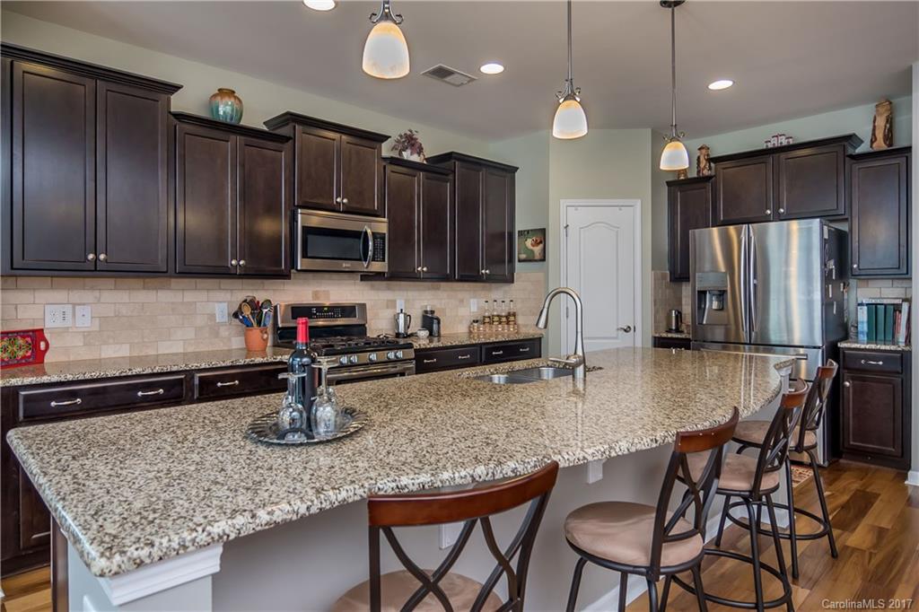 4229 Perth Road, Unit 10 Indian Land, SC 29707 - Photo 8 of 24 a kitchen with stainless steel appliances granite countertop a sink refrigerator and microwave
