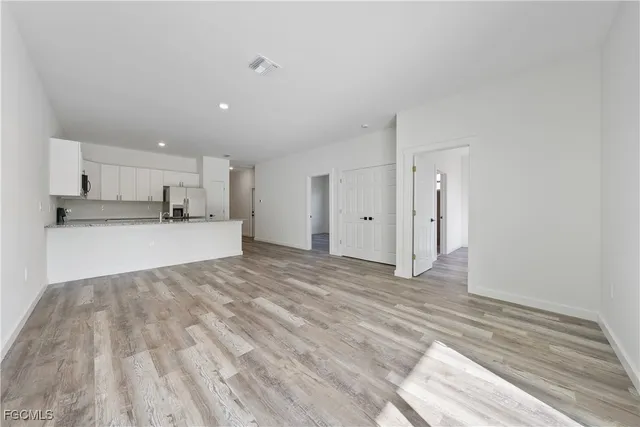 a view of a kitchen with a sink and cabinets
