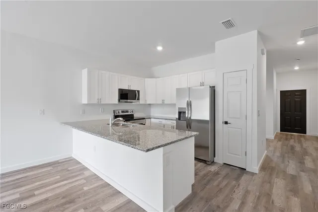 a kitchen with a sink stove and refrigerator