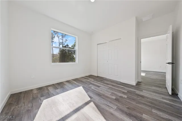 a view of a room with wooden floor and window