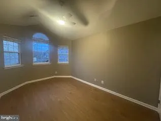 an empty room with a empty space and windows
