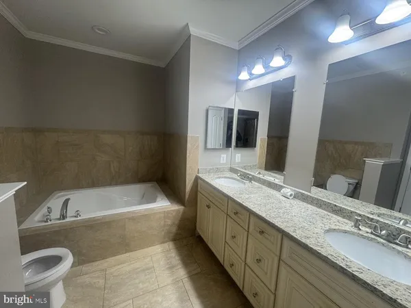 a spacious bathroom with a bathtub sink and toilet