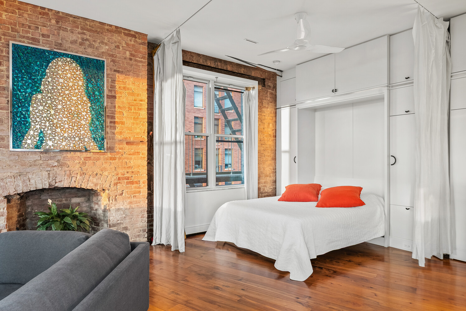 214 Riverside Drive, Unit 508/509 Manhattan, NY 10025 - Photo 10 of 17 a bedroom with a bed mirror and window