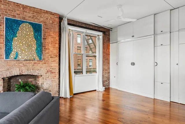 a bedroom with a bed mirror and window