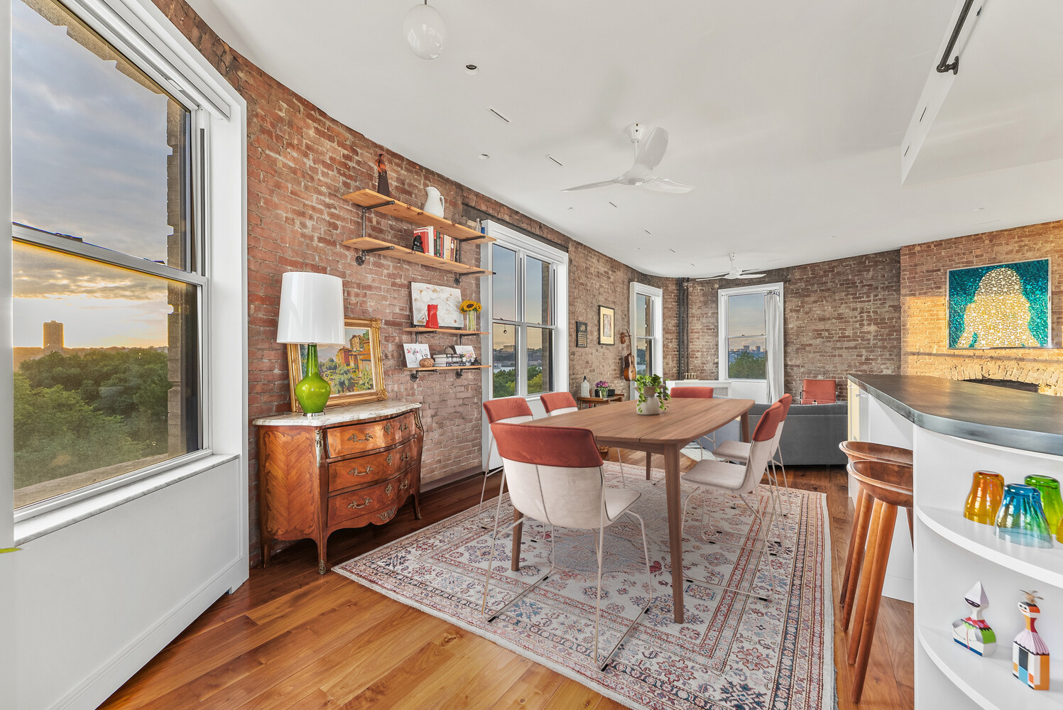 214 Riverside Drive, Unit 508/509 Manhattan, NY 10025 - Photo 4 of 17 a living room with furniture a flat screen tv and a floor to ceiling window