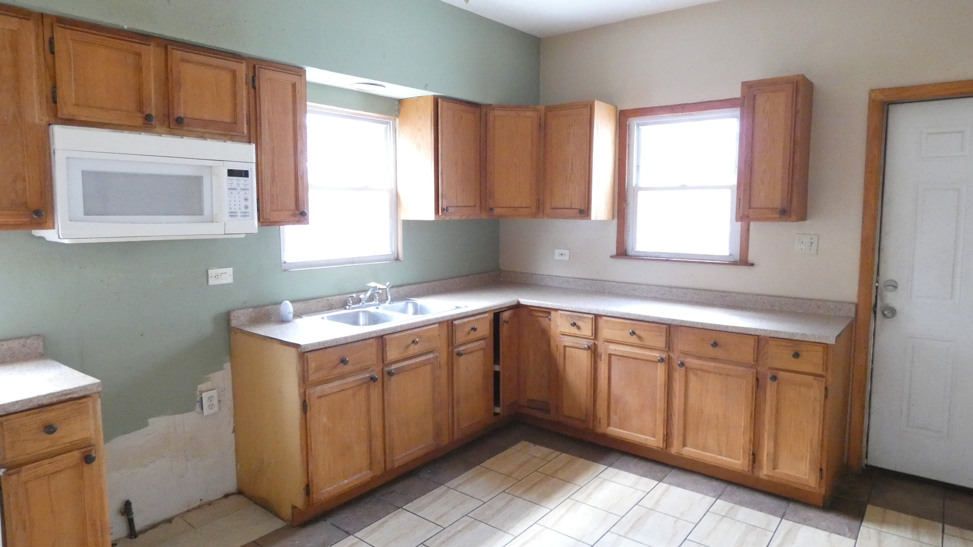 Undisclosed Address Chicago, IL 60628 - Photo 18 of 20 a kitchen with a sink cabinets and a window