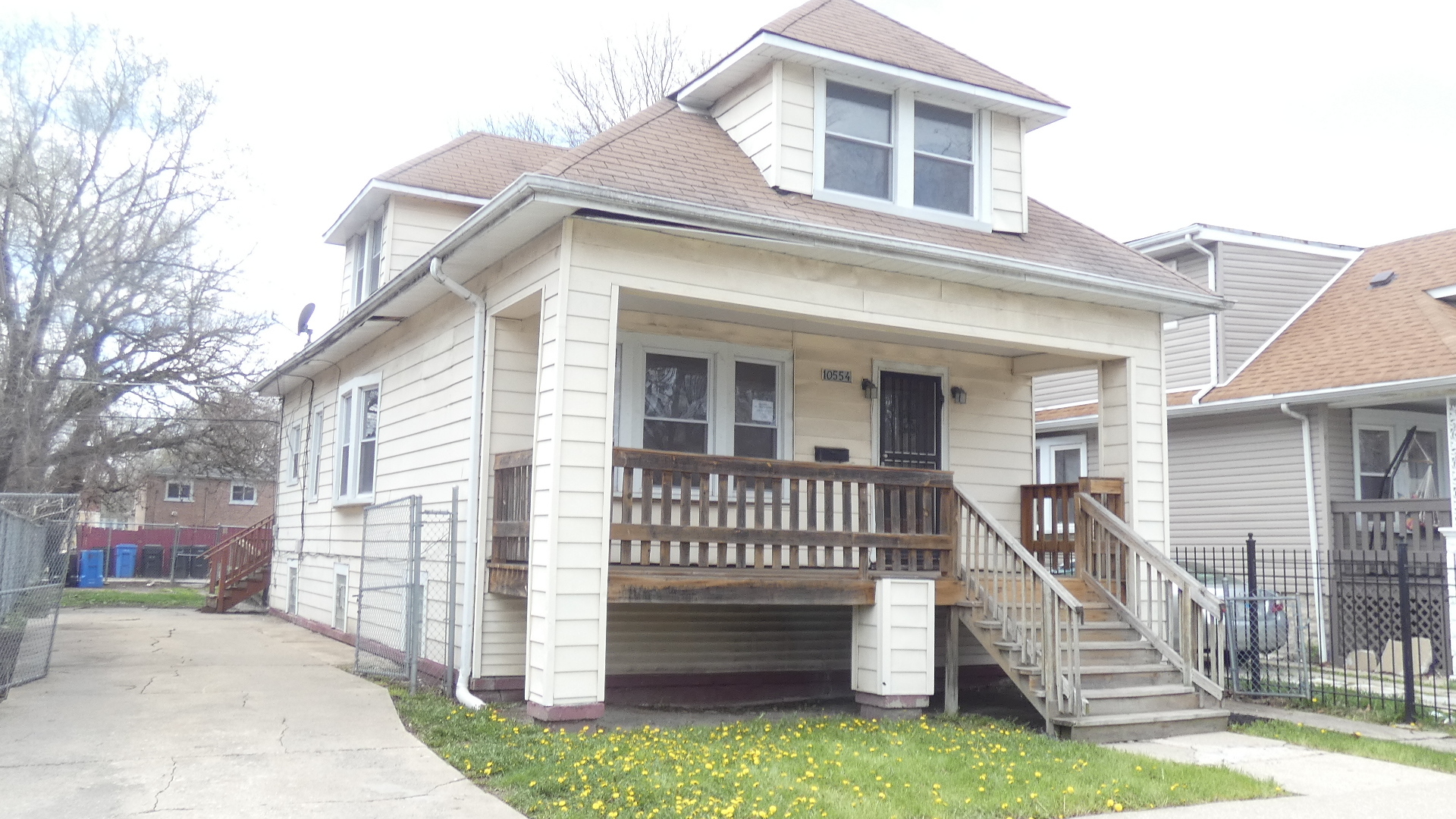 Undisclosed Address Chicago, IL 60628 - Photo 2 of 20 front view of a house with a bench