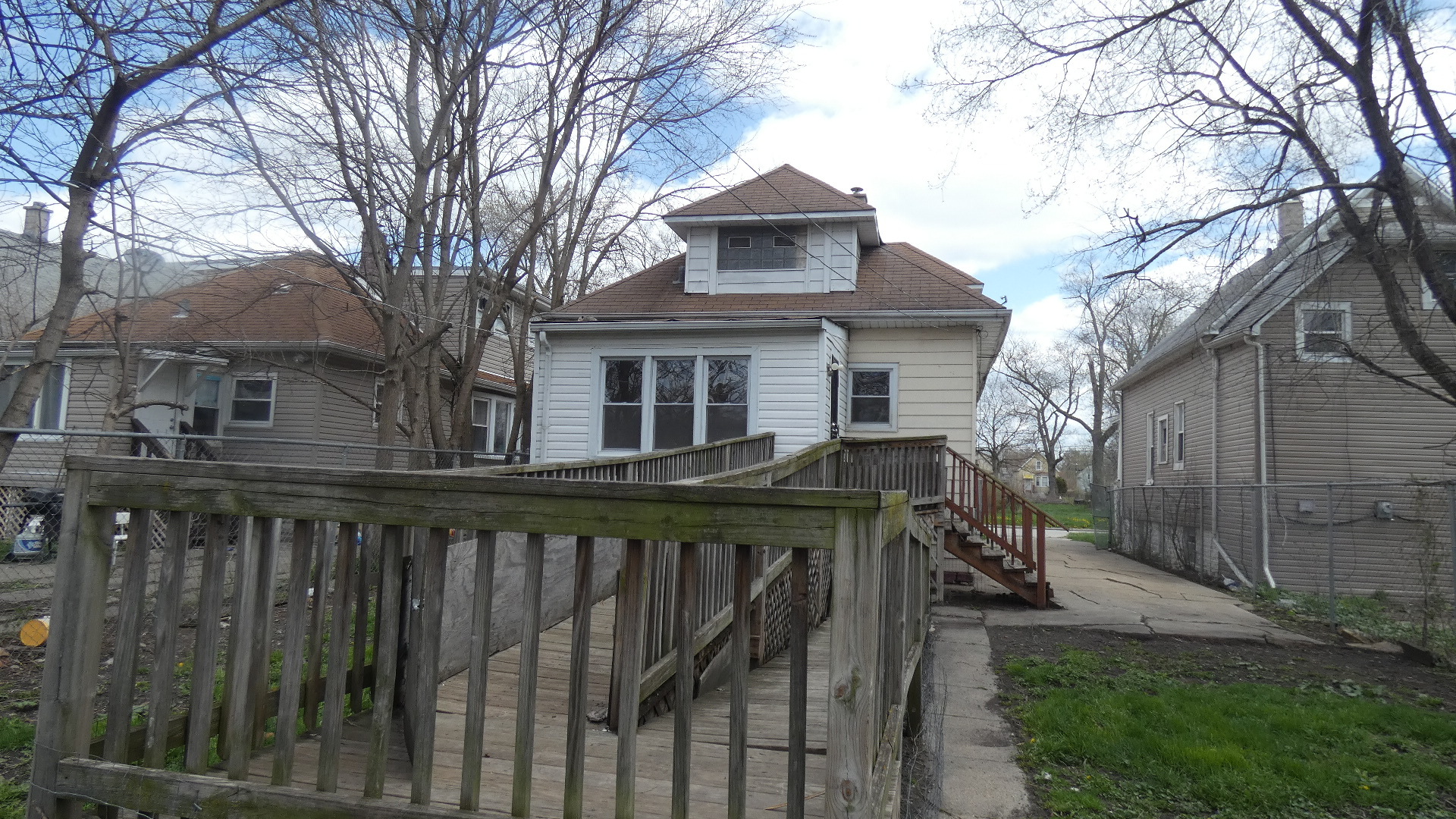 Undisclosed Address Chicago, IL 60628 - Photo 3 of 20 a view of house with a yard and trees