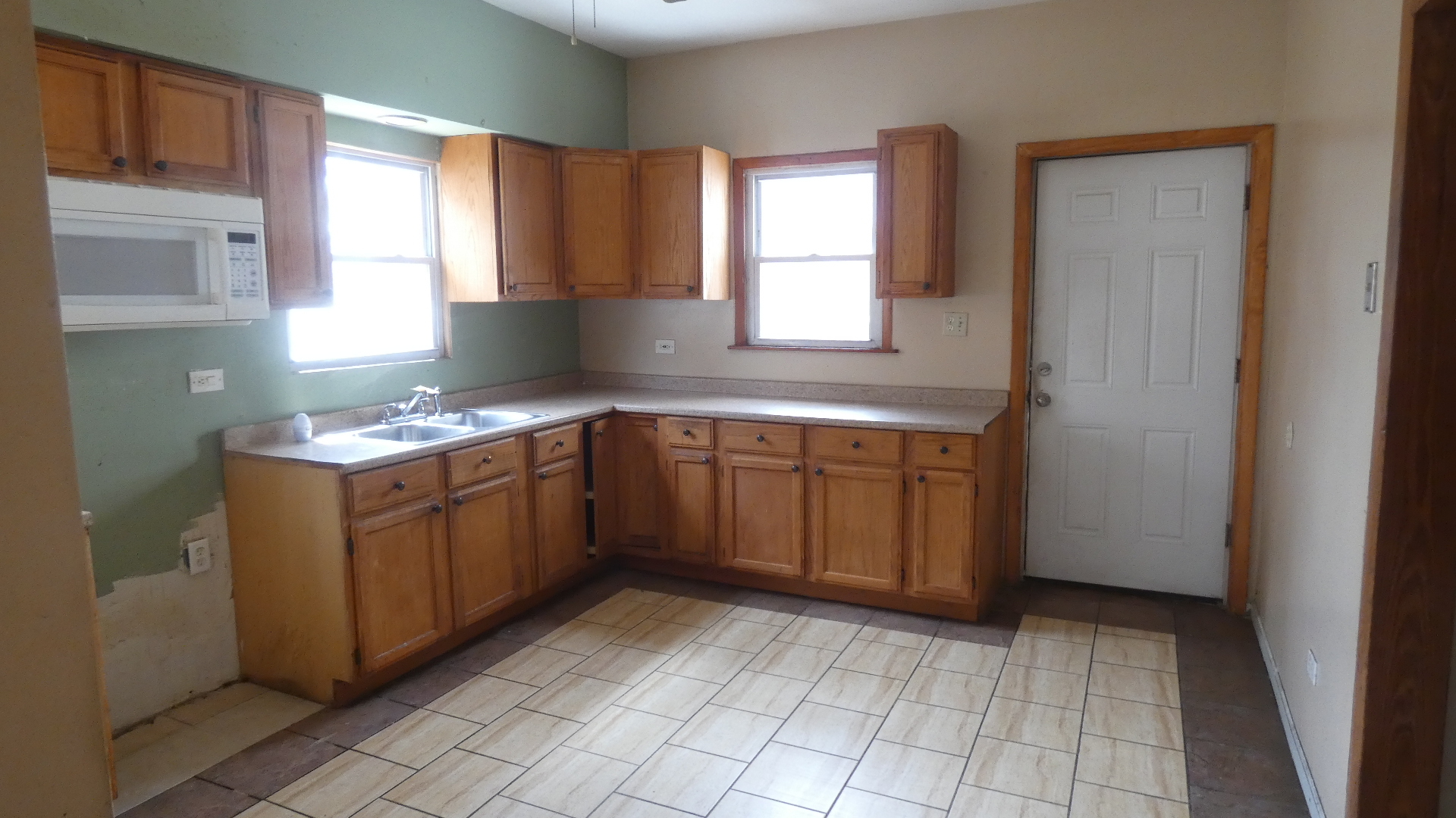 Undisclosed Address Chicago, IL 60628 - Photo 6 of 20 a kitchen with a stove sink and cabinets
