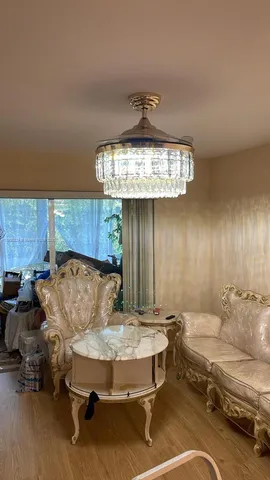 a living room with a couch and chandelier