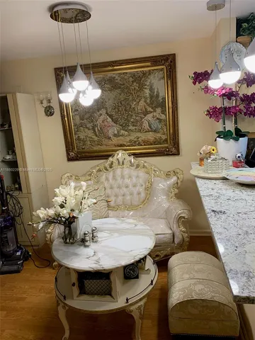 a dining room with furniture and wooden floor